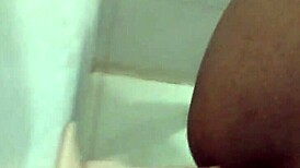 Amateurs experiment with dildo in the bathroom setting.