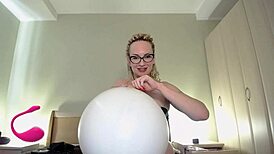 Hey, watch this curvy babe blow to pop a white balloon! 😍