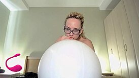 Hey, watch this curvy babe blow to pop a white balloon! 😍