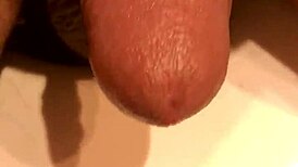 Guy jerks his soft cock in the bathroom