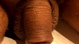 Guy jerks his soft cock in the bathroom