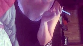 Watch her smoke while giving a blowjob, those tits bouncing in the fetish scene.