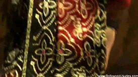 Teasing nude brunette dances erotically in oriental setting