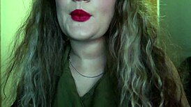 Cute woman paints her lips red and smokes a cigarette. I hope you like it.