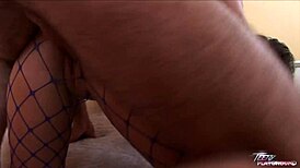 Barely eighteen brunette hottie poses bent over in fishnet.