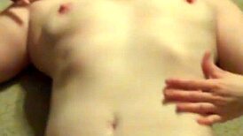 A redhead woman showcases her ginger-colored breasts in a natural setting.