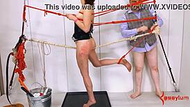 Submissive slut toyed with anal dildo in rough BDSM session.