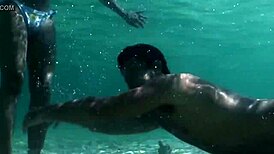 Croc sexy bikini girl posing on the beach with a playful twist