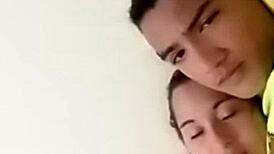 sexy couple lounging in bed sharing laughs and cuddles with soft music playing in the background