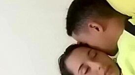 sexy couple lounging in bed sharing laughs and cuddles with soft music playing in the background