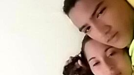 sexy couple lounging in bed sharing laughs and cuddles with soft music playing in the background