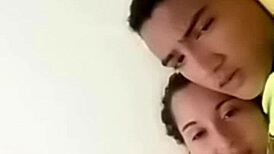 sexy couple lounging in bed sharing laughs and cuddles with soft music playing in the background