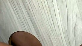 Eagerly sucking massive cock through the gloryhole setup