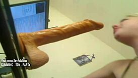 Blonde deep throats huge dildo in hardcore action