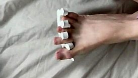 she paints her toenails and invites the neighbor for a footjob, filling her feet with his cum