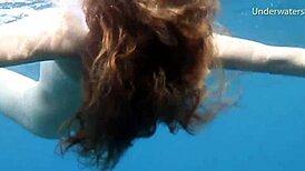 hot ginger swims underwater in tenerife pool