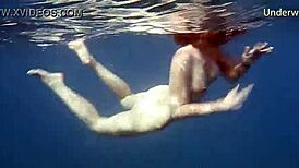 hot ginger swims underwater in tenerife pool