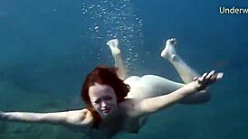 hot ginger swims underwater in tenerife pool