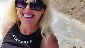 Nude milf boldly exposed in public outdoor setting.