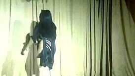 Stripper girl performs hot striptease with clothes ripped.