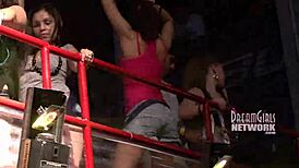 Spring break club flashing in night club outdoor setting.