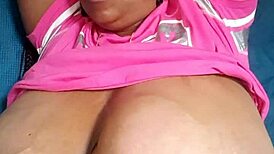 The ebony beauty with green eyes showcases her big tits in a captivating display.