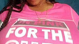 The ebony beauty with green eyes showcases her big tits in a captivating display.