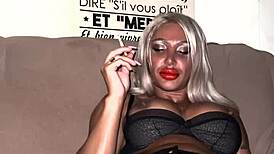 Busty muscle girl lights up a cigarette with fierce athletic charm.