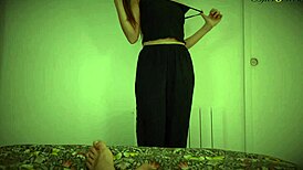 Teen performs enticing striptease undressing slowly