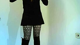 Transsexual crossdresser in black boots showing off shemale features