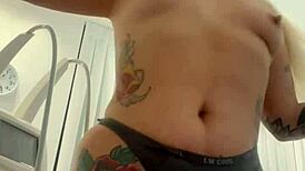 Blonde Tattoo Tease Removing Clothes