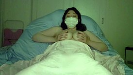 Japanese milf with big tits masturbates before bed in a chubby self-shot video.