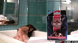 Cute brunette enjoys a relaxing bath with toys