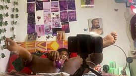 She masturbates alone with a dildo, fingering her pussy while bent over in front of the mirror.