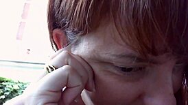 Nicoletta in her rich garden trying earrings, feeling so excited for ear lovers