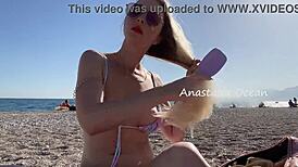 Sexy blonde shows off her stunning breasts on public beach