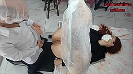 Shady doctor examines pale girl in his hidden office space.