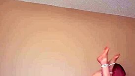 Bound wife experiences intense bondage session.