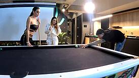 Two fiery latinas engage in threesome with big cocks on pool table, sucking and fucking