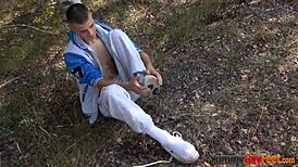 I see gay twink jacking off and cumming with footjob outdoors