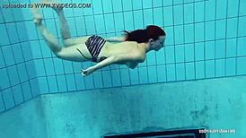 Redheaded Katrin Strips Underwater in Teasing Solo with Ripped Clothes and Tattoos