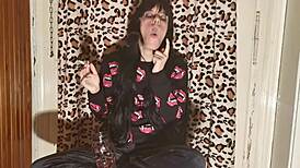 smoking goth girl relaxes behind the scene after a long day?