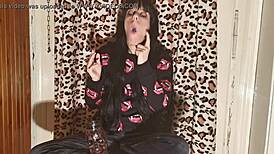 smoking goth girl relaxes behind the scene after a long day?
