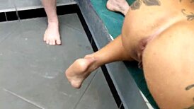 two naked girls playing with hose make a silver rain