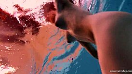 Feeling the thrill of firm tits in red dress underwater