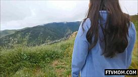 Busty Asian milf flashes big tits in daring public outdoor nude scene. Crowd watches stunned.