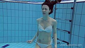 Roxalana Cheh feels the thrill as sexy redhead underwater with tight shaved ass