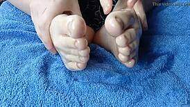 Close-up of oiled feet in homemade video