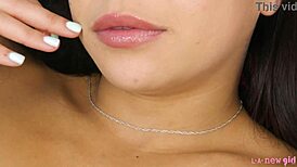 cute brunette teen sits on sofa and shows her body in interview