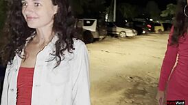 Two Girlfriends Pee Together by Car in Public Parking Lot